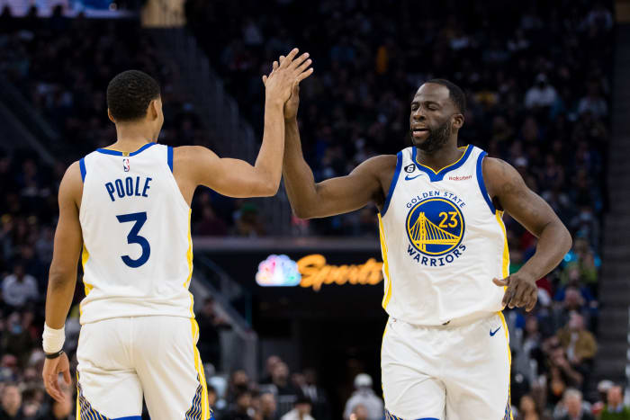 Golden State Warriors guard Jordan Poole (3) and forward Draymond Green (23) celebrate after Poole drew a foul against the Brooklyn Nets during the first half at Chase Center.